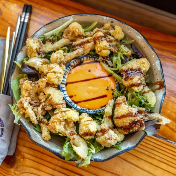 Crispy fried cauliflower florets with a sweet glaze, served with a creamy orange dipping sauce.